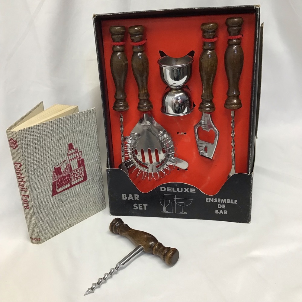 Vintage 1960s dead stock bar accessories set and Cocktail Fare book bar display